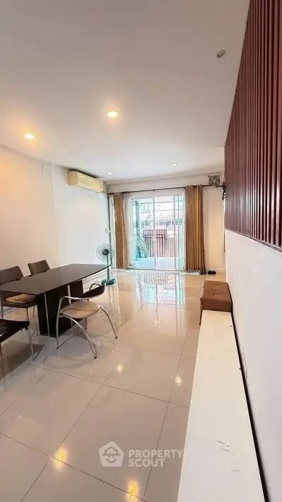 Spacious living room with modern decor and large window for natural light.