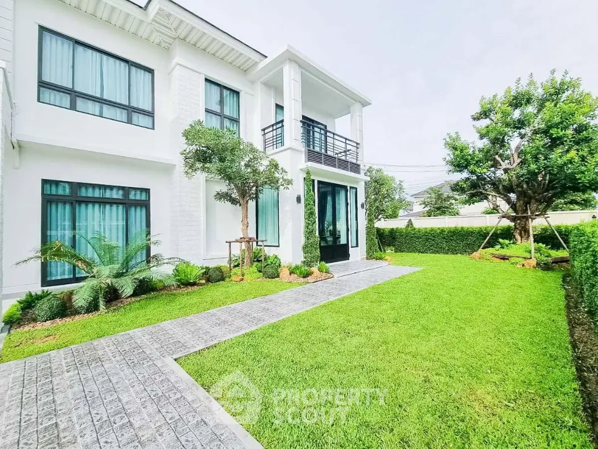 Stunning modern home with lush green lawn and elegant facade