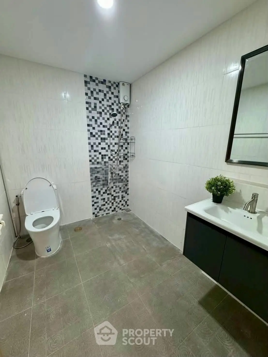 Modern bathroom with sleek design and stylish tile accents, featuring a shower and vanity.