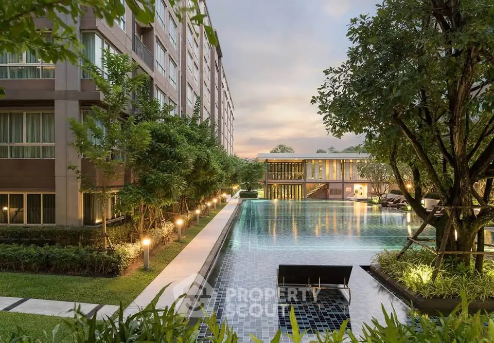 Luxurious apartment complex with stunning pool and lush greenery, perfect for modern living.