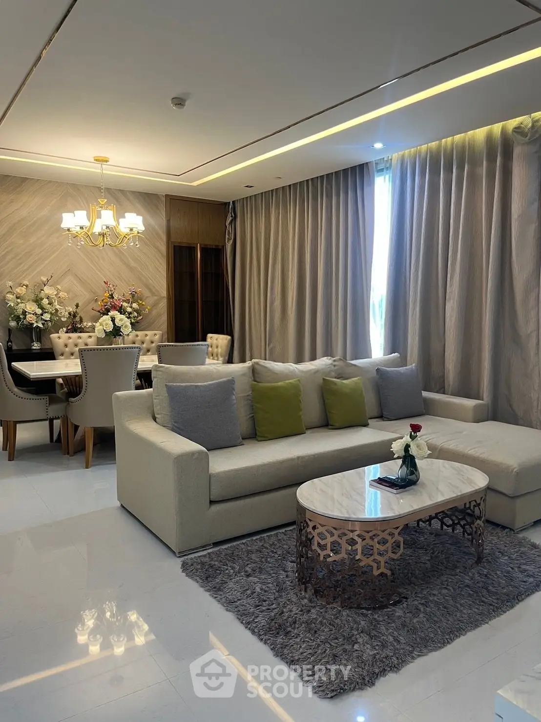 Luxurious living room with elegant dining area, plush sofa, and chic decor in modern apartment.