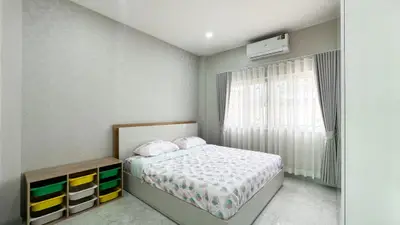 Modern bedroom with stylish decor and ample natural light