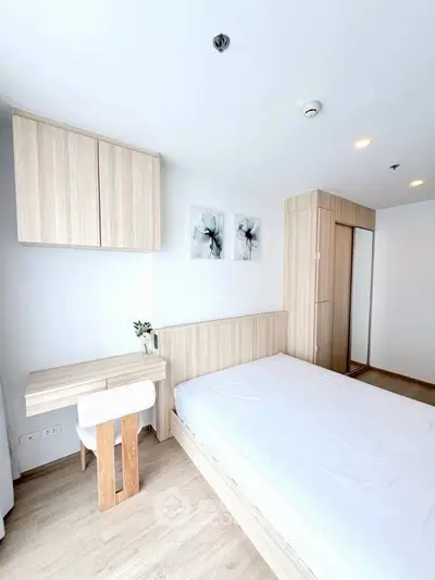 Modern minimalist bedroom with wooden furniture and bright natural lighting