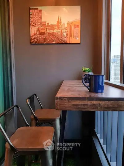 Chic balcony with modern seating and cityscape view, perfect for relaxation and enjoying urban scenery.