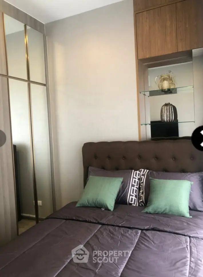 Modern bedroom with stylish decor and mirrored wardrobe