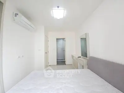 Modern minimalist bedroom with air conditioning and ensuite bathroom