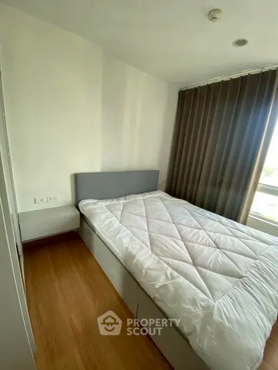 Cozy bedroom with modern decor and large window for natural light