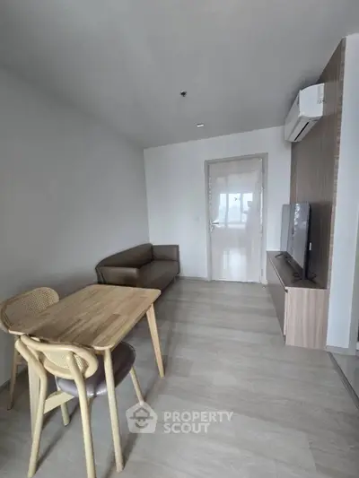 Modern minimalist living room with sleek furniture and natural light.