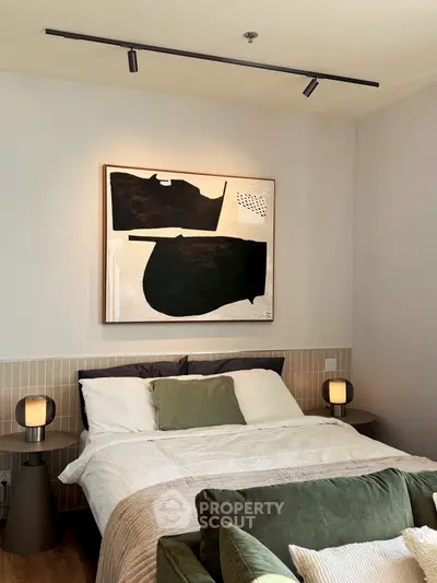 Modern bedroom with stylish decor and abstract art, featuring cozy bedding and ambient lighting.