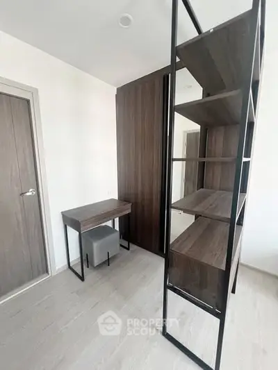 Modern study room with sleek wooden desk and shelving unit, perfect for productivity.