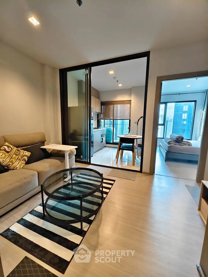 Modern apartment interior with cozy living room, stylish kitchen, and inviting bedroom view.
