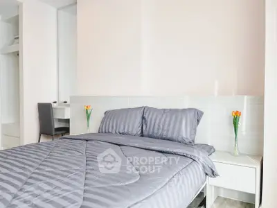 Modern bedroom with stylish decor and cozy bedding in a bright apartment.