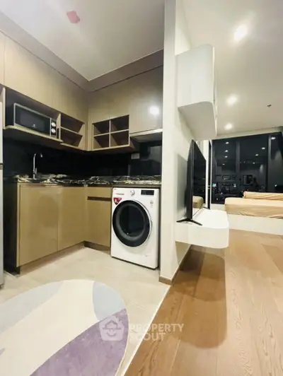Modern apartment interior with open kitchen and washing machine