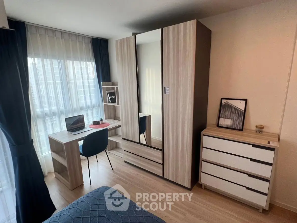 Modern bedroom with stylish furniture and city view, perfect for urban living.