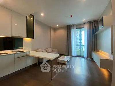 Modern open-plan living room with sleek kitchen and balcony view