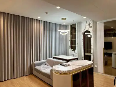 Luxurious modern living room with elegant marble accents and stylish lighting