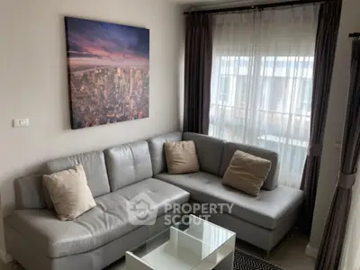 Modern living room with stylish gray sofa and cityscape artwork