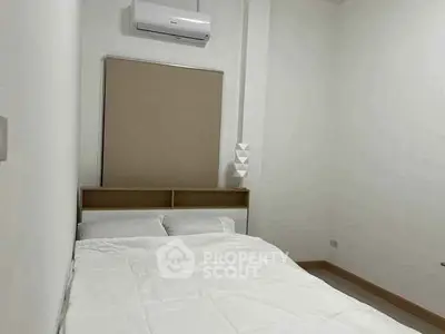 Cozy minimalist bedroom with air conditioning and neutral decor