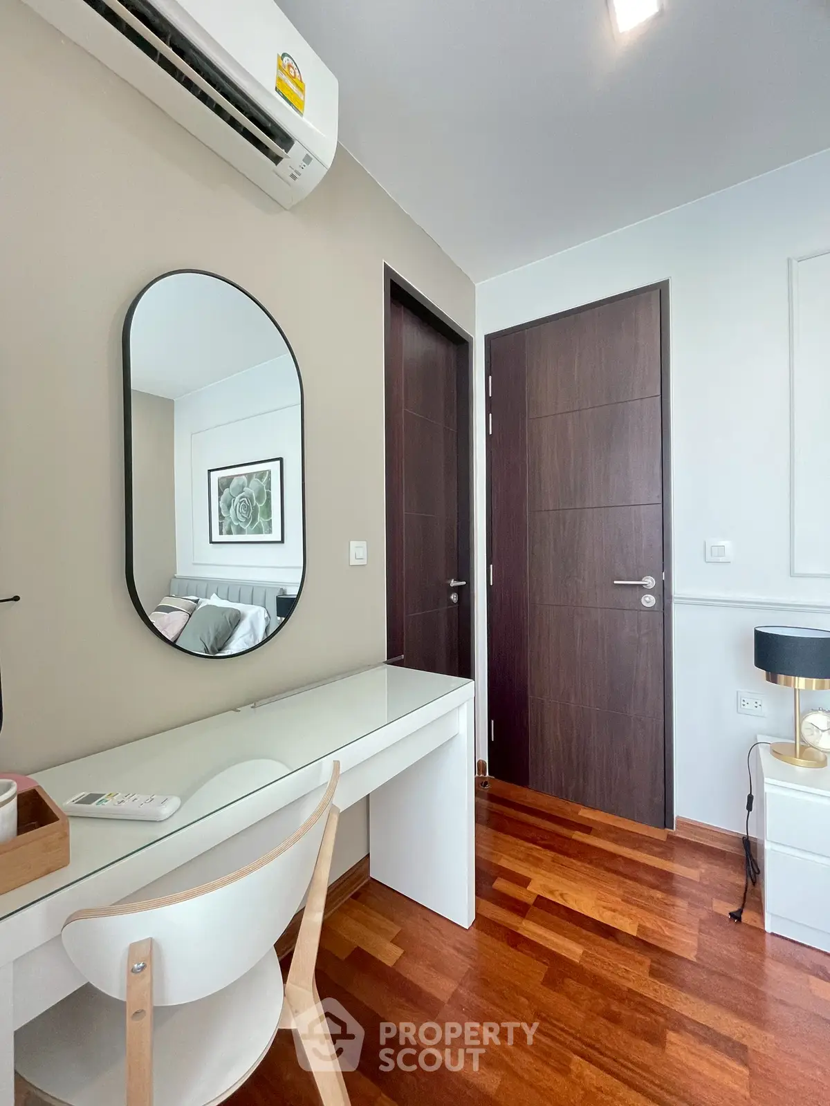 Modern study area with sleek desk and mirror in stylish apartment