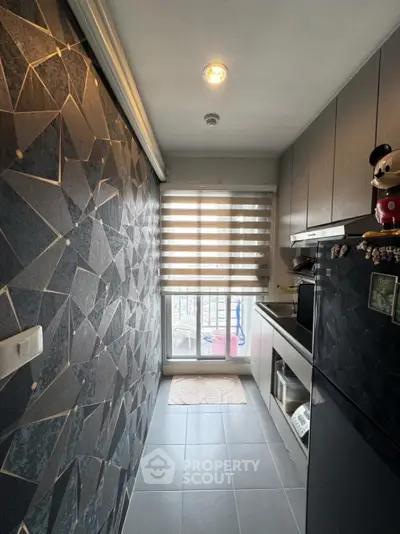 Modern kitchen with geometric wall design and balcony view