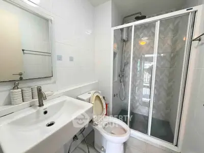 Modern bathroom with sleek shower and contemporary fixtures in a stylish apartment.