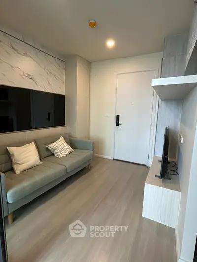 Modern living room with sleek design and cozy sofa, perfect for relaxation.