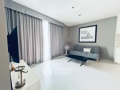 Modern living room with sleek gray sofa and elegant decor, perfect for stylish urban living.