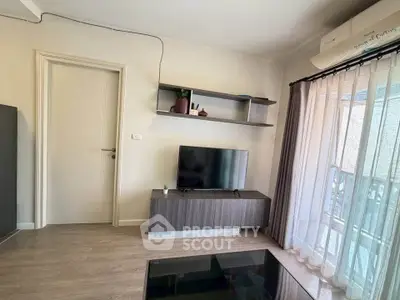 Modern living room with TV, shelves, and balcony view