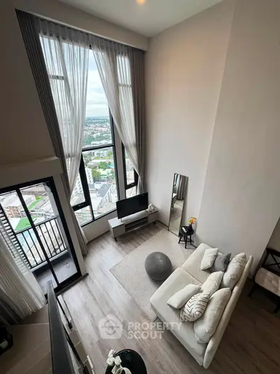 Stunning high-rise living room with floor-to-ceiling windows and breathtaking city view.