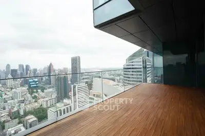 Spacious balcony with stunning city skyline view in modern high-rise building.