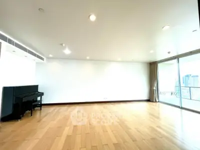 Spacious living room with wooden flooring and city view balcony