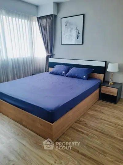 Modern bedroom with stylish wooden flooring and elegant decor