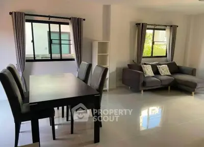 Spacious modern living room with dining area and large windows
