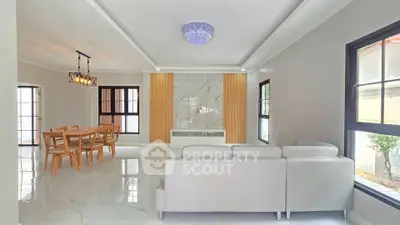 Spacious modern living room with elegant dining area and stylish lighting