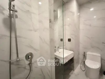 Luxurious modern bathroom with marble walls and sleek fixtures