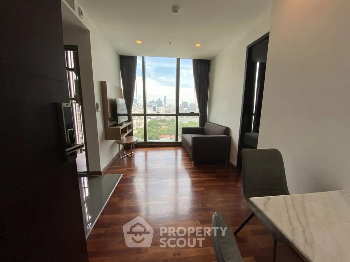 Modern living room with city view, hardwood floors, and stylish furniture