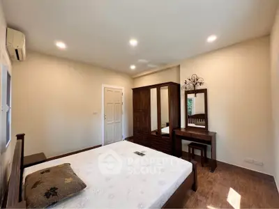Spacious bedroom with elegant wooden furniture and natural light