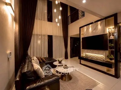 Luxurious double-height living room with elegant decor and modern lighting
