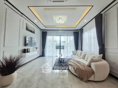 Luxurious modern living room with elegant decor and large windows for natural light.