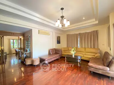 Spacious living room with elegant lighting and hardwood floors in a modern home.