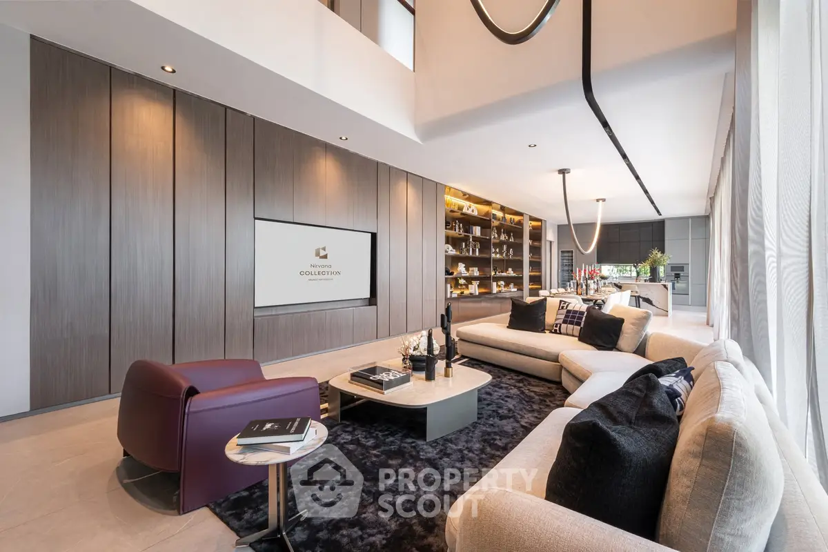 Luxurious modern living room with elegant furniture and open kitchen layout, perfect for entertaining.