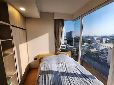 Modern bedroom with panoramic city view and ample natural light