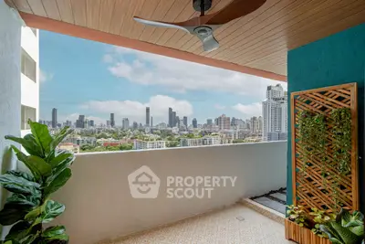 Stunning balcony view of city skyline with lush greenery and modern decor