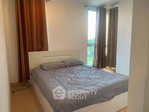 Cozy bedroom with natural light and modern decor in a stylish apartment.