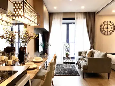 Luxurious modern living room with elegant decor and open layout, featuring a stylish chandelier and cozy seating area.