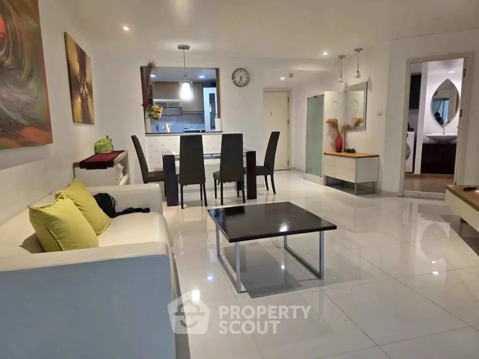 Spacious modern living room with sleek furniture and open layout, perfect for entertaining.