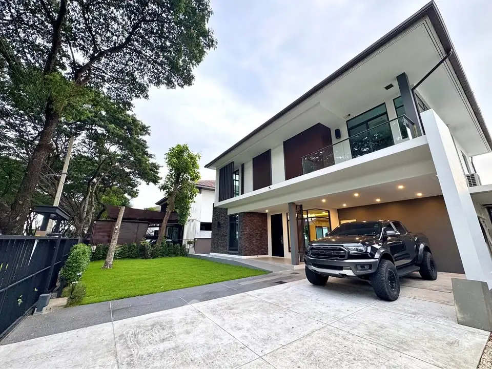 Modern two-story house with spacious driveway and lush green lawn