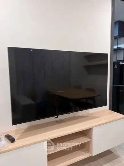 Modern living room with sleek TV setup and stylish wooden furniture