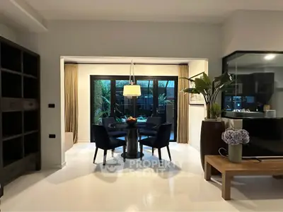 Modern dining area with elegant decor and large windows overlooking a garden, perfect for stylish living.