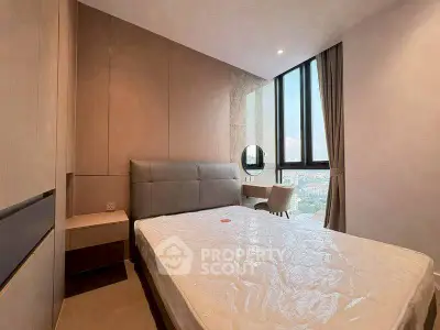 Modern bedroom with large windows and stylish decor in a high-rise apartment.